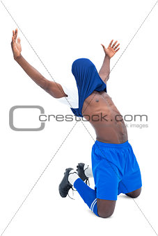 Football player in blue celebrating a win