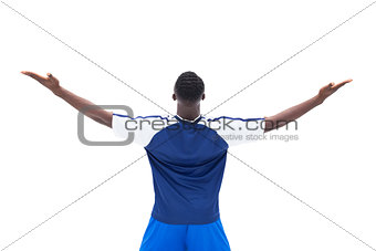Football player in blue celebrating a win