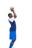 Football player in blue throwing ball