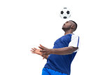 Football player in blue heading ball