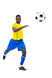 Football player in yellow kicking ball