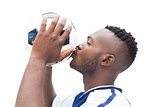 Football player in blue kissing ball