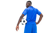 Football player in blue holding ball