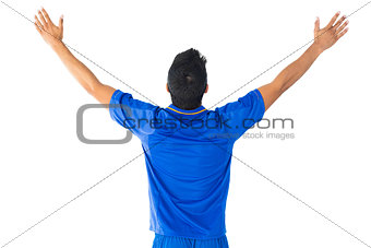Happy football player in blue celebrating