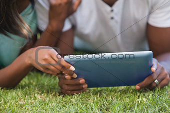 Couple using tablet together outside