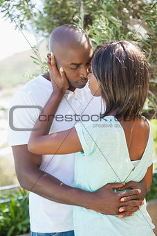 Attractive couple embracing in their garden