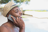 Handsome shirtless man talking on phone