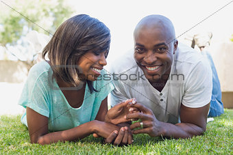 Happy couple lying in garden together