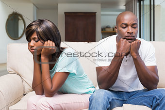 Unhappy couple having an argument on the couch