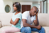 Unhappy couple not talking after argument on sofa