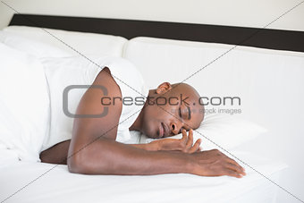Peaceful man sleeping in bed