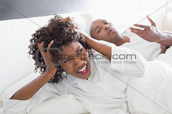 Young couple arguing in bed