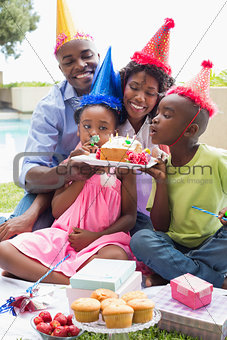 Happy family celebrating a birthday together in the garden