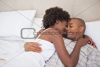 Happy couple in bed together
