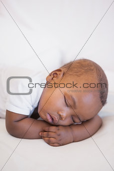 Baby boy sleeping peacefully on couch