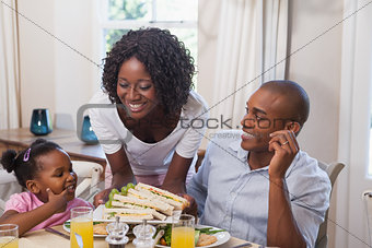 Mother serving sandwiches to her family