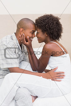 Happy couple showing affection on bed