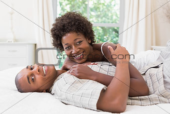 Happy couple lying in bed together