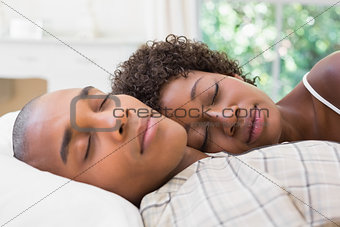 Happy couple sleeping in bed together