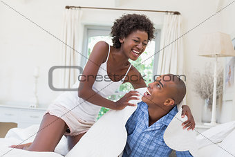 Silly couple having fun on bed together