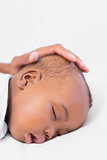 Adorable baby boy sleeping with fathers hand on head