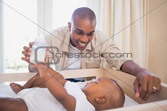 Happy father about to feed his son