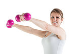 Smiling young woman with dumbbells