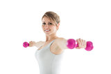 Smiling young woman with dumbbells