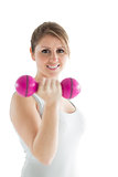 Smiling young woman with dumbbell