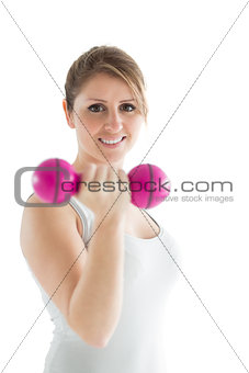 Smiling young woman with dumbbell