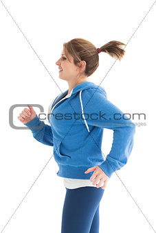 Side view of a young woman running