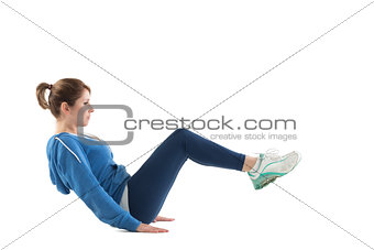Side view of woman in core balance pilates pose