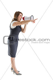 Young woman shouting into bullhorn as she gestures