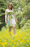 Cute young woman standing in field