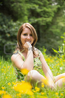 Cute young woman relaxing in field