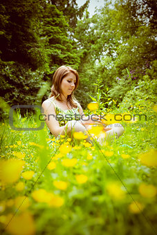 Thoughtful woman relaxing in field