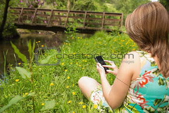 Woman text messaging in field
