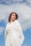 Woman looking away against blue sky and clouds