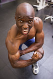 Muscular man shouting while flexing muscles