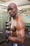 Shirtless muscular man standing in gym
