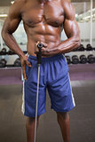Muscular man using resistance band in gym