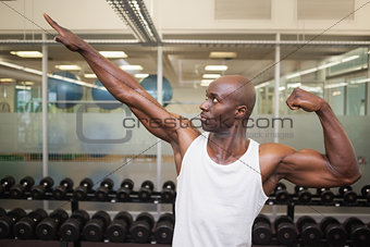 Muscular man posing in gym