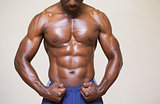 Shirtless young muscular man flexing muscles