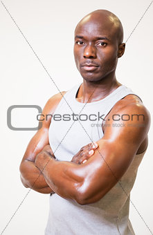 Portrait of a serious muscular man with arms crossed