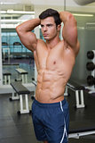 Muscular man looking away in gym