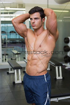 Muscular man looking away in gym