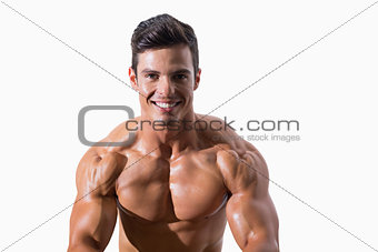 Portrait of a smiling shirtless muscular man