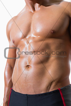 Mid section of shirtless muscular man