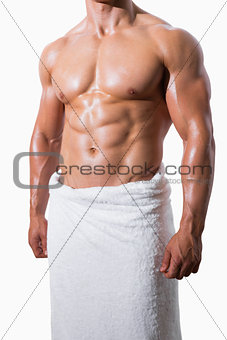 Shirtless muscular man in white towel