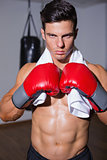 Shirtless muscular boxer in defensive stance